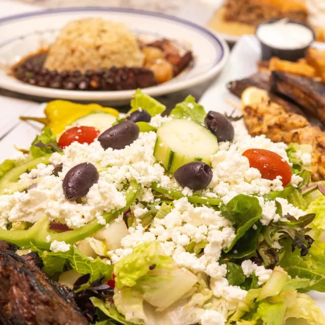 Greek salad beside octopus stifado