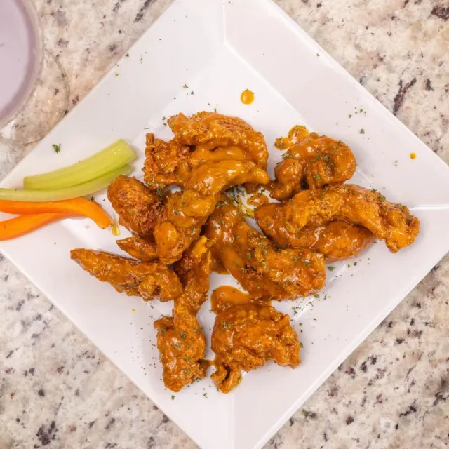 Fresh chicken wings with celery and carrots